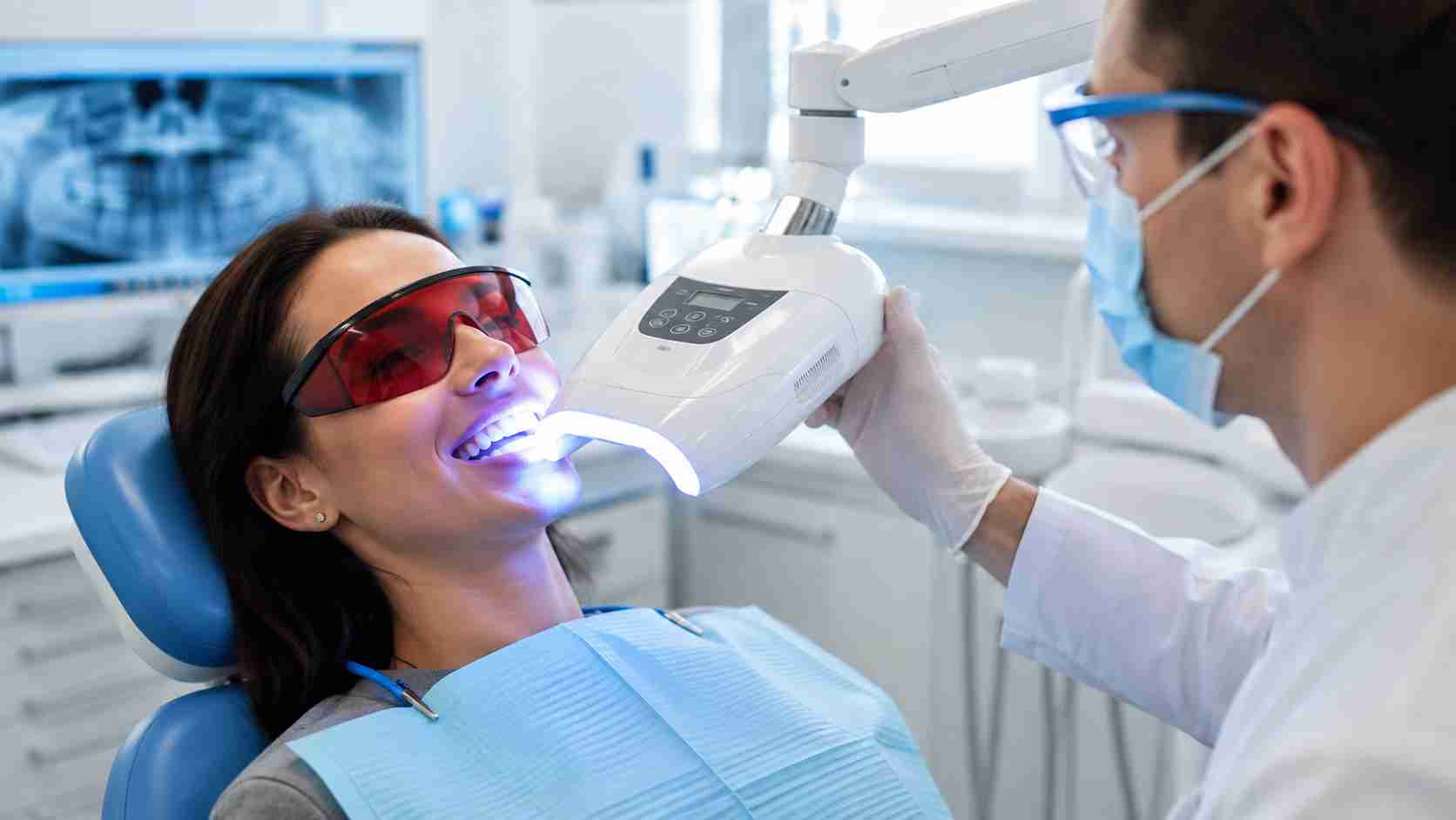 Patient receiving Zoom teeth whitening treatment at a dental clinic