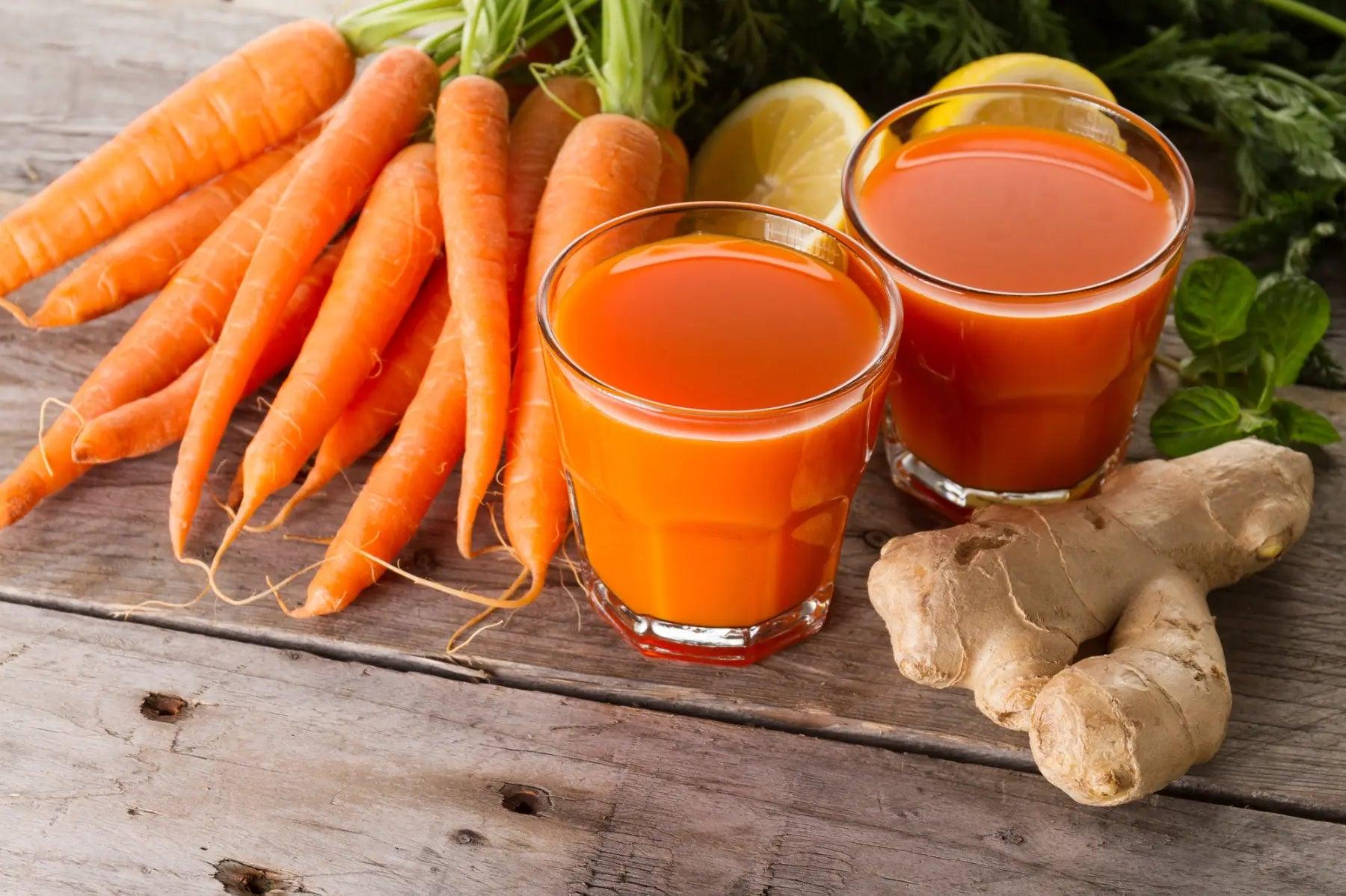 Fresh carrot and ginger juice served with carrots and lemon.